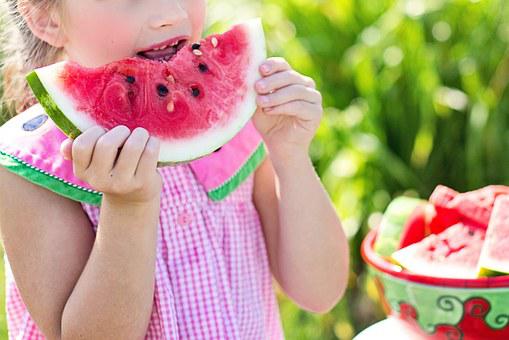 Joyful Child Enjoying Watermelon Slice