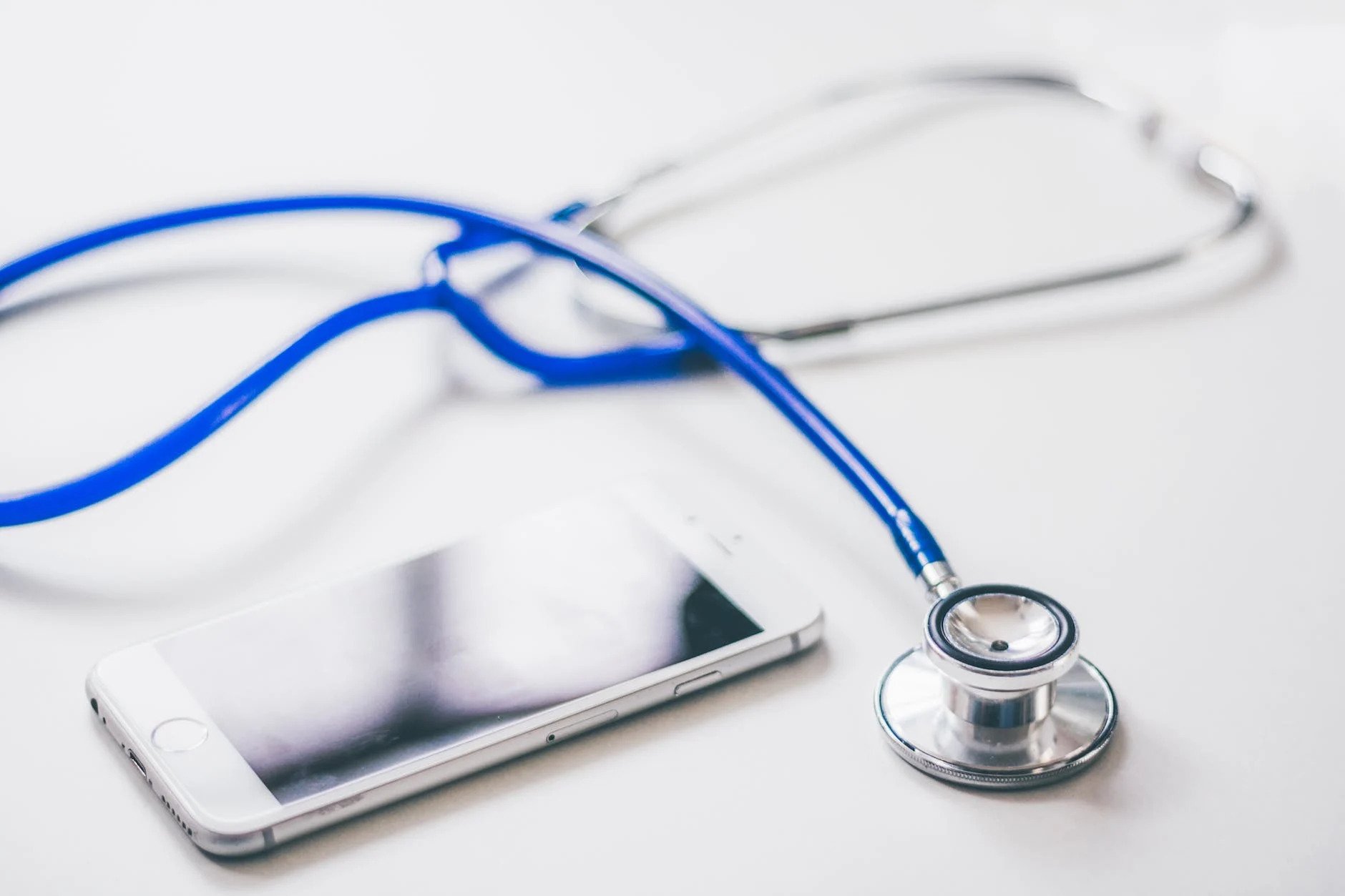 Stethoscope And Smartphone On A White Surface